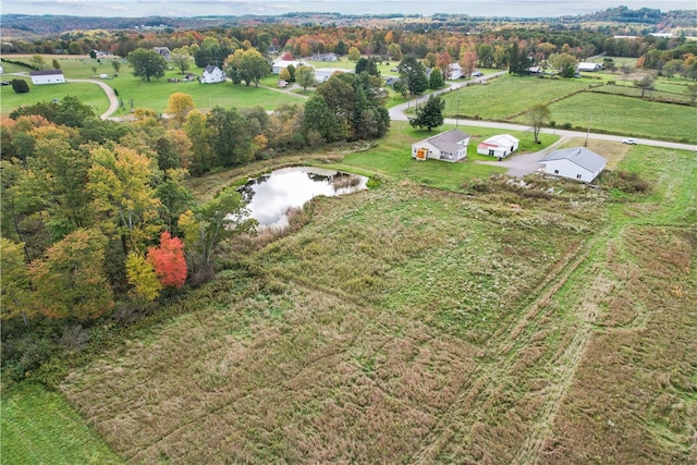 drone / aerial view featuring a rural view and a water view