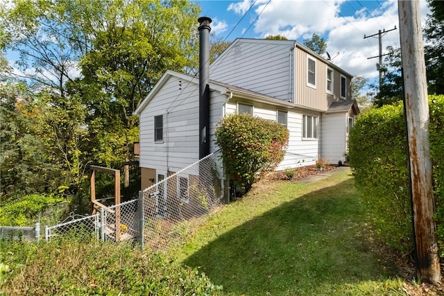 view of side of property with a yard