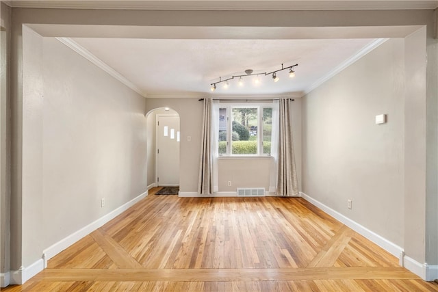 foyer featuring ornamental molding and wood-type flooring