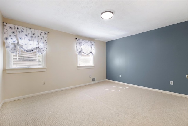 unfurnished room featuring carpet