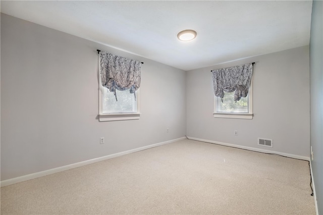 unfurnished room featuring a healthy amount of sunlight and carpet floors