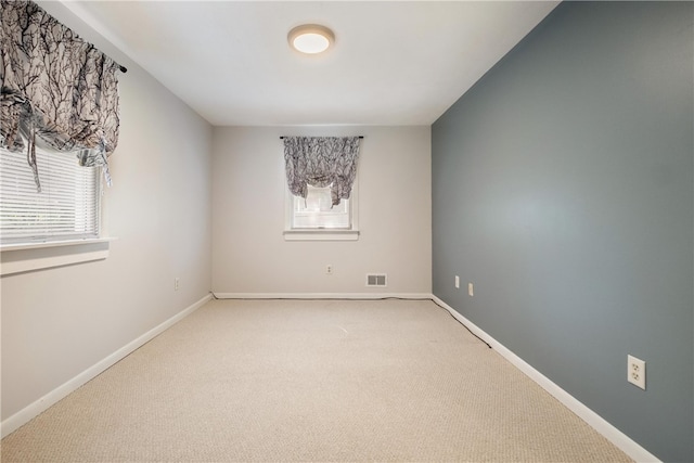 spare room with carpet floors and plenty of natural light