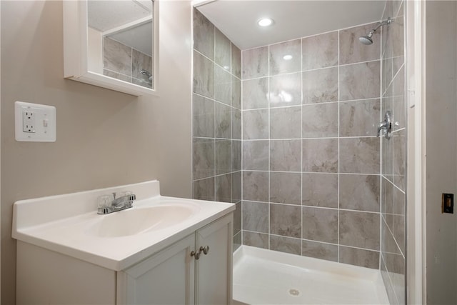 bathroom featuring vanity and a tile shower