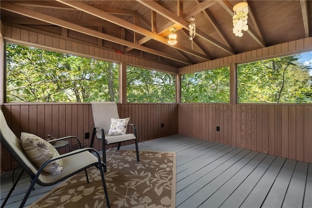 sunroom with vaulted ceiling with beams, wood ceiling, and a wealth of natural light