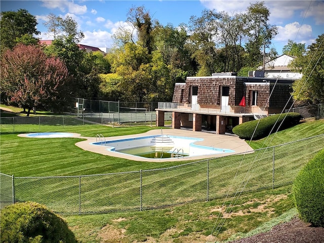 view of swimming pool featuring a patio and a yard