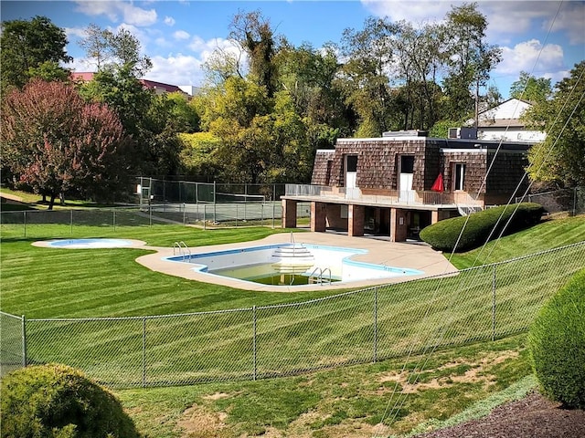 exterior space with a patio area, a fenced backyard, a fenced in pool, and a lawn