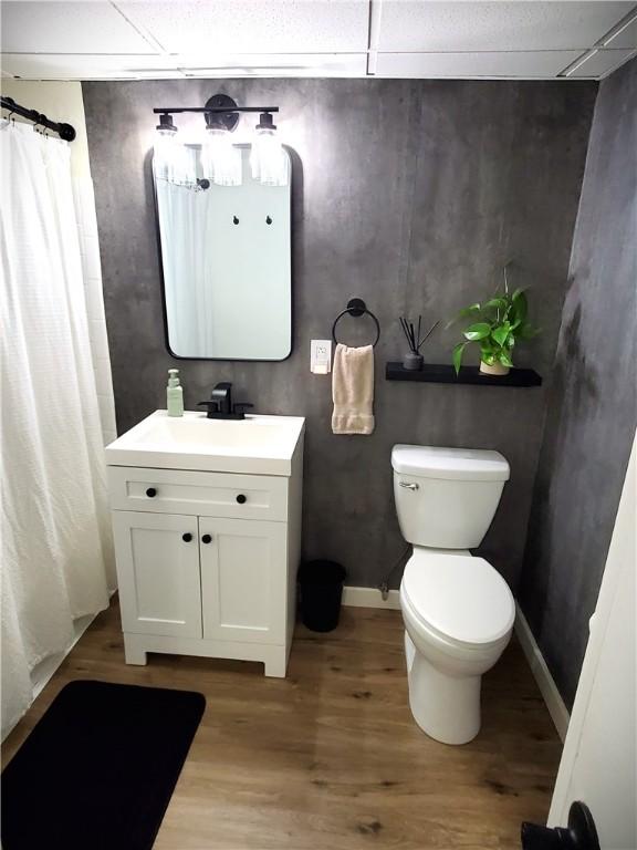 full bathroom featuring toilet, curtained shower, vanity, and wood finished floors