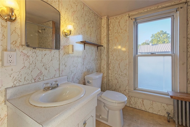 bathroom with tile patterned floors, vanity, toilet, and a shower with shower door