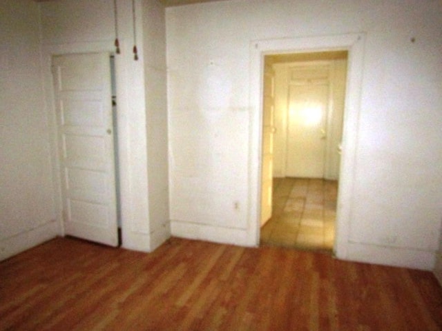 unfurnished bedroom with light wood-type flooring
