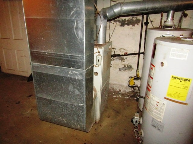 utility room featuring heating unit and water heater