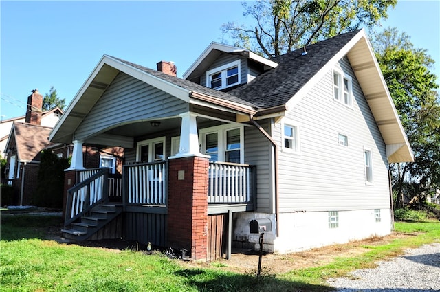 rear view of house featuring a porch