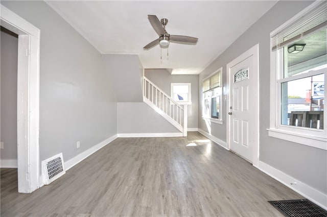 foyer entrance with light hardwood / wood-style flooring and ceiling fan