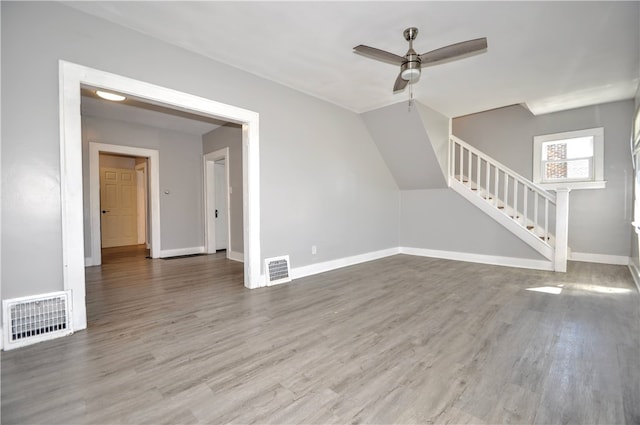 unfurnished living room featuring ceiling fan and hardwood / wood-style floors