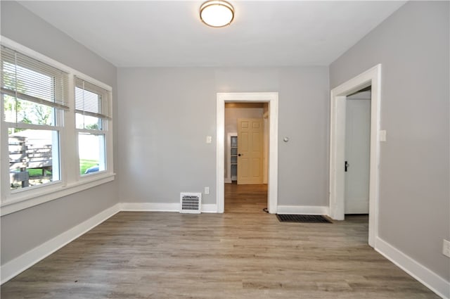 spare room with light wood-type flooring