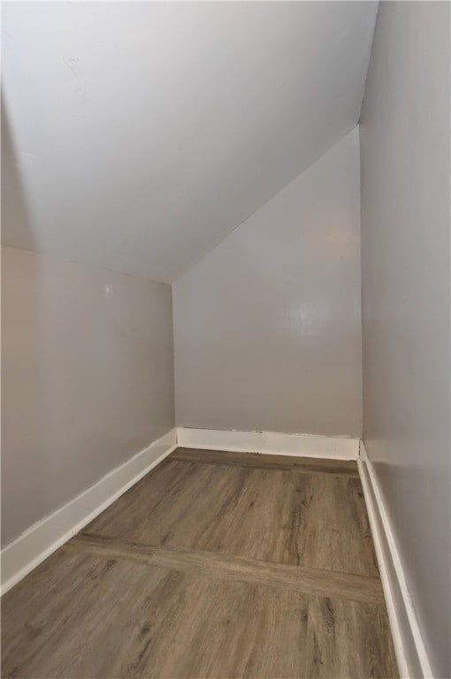 bonus room featuring hardwood / wood-style floors and vaulted ceiling