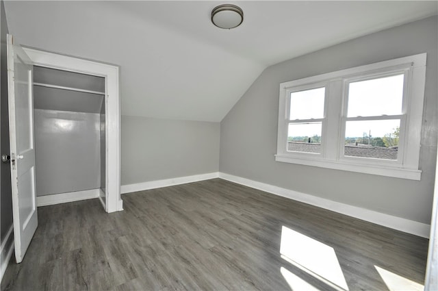 bonus room featuring lofted ceiling and dark hardwood / wood-style flooring