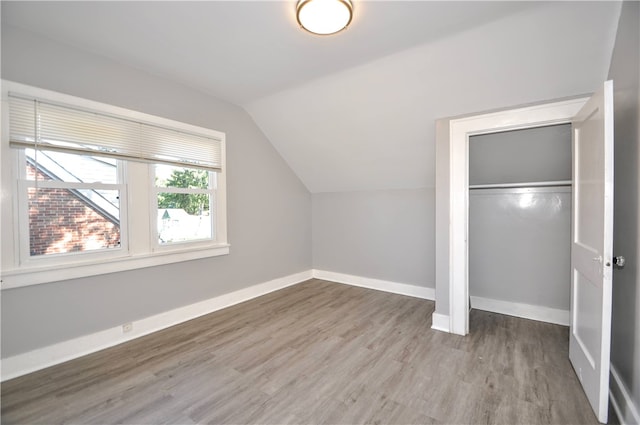 bonus room with lofted ceiling and hardwood / wood-style flooring