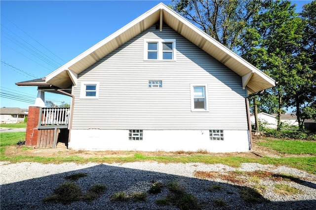 view of home's exterior featuring a wooden deck