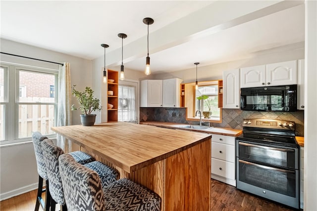 kitchen featuring dark hardwood / wood-style flooring, stainless steel electric range oven, sink, and white cabinets