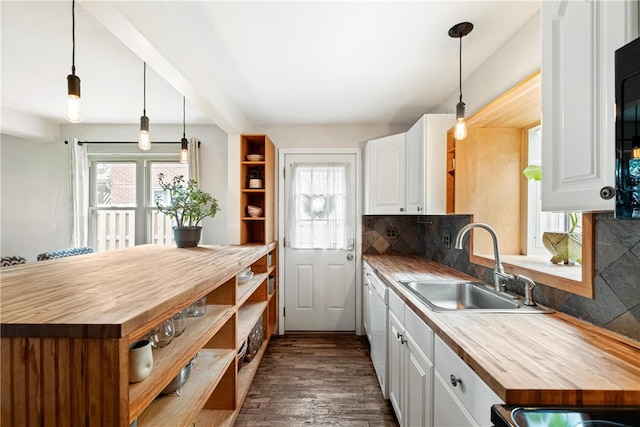 kitchen featuring white cabinetry, dark hardwood / wood-style floors, pendant lighting, and backsplash