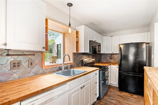 kitchen featuring wooden counters, hanging light fixtures, sink, white cabinetry, and appliances with stainless steel finishes