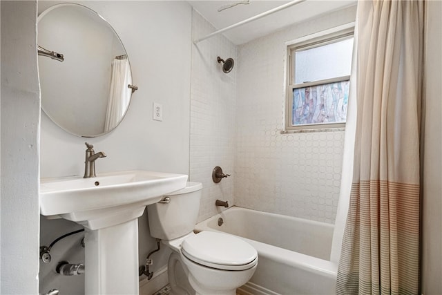 bathroom featuring shower / bath combination with curtain and toilet