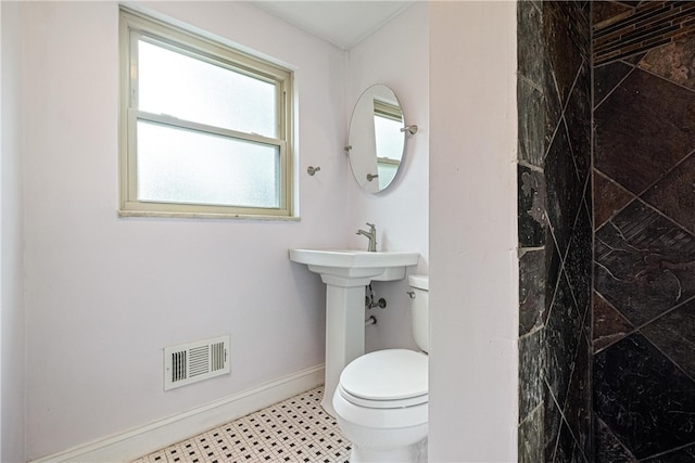 bathroom featuring tile patterned flooring and toilet