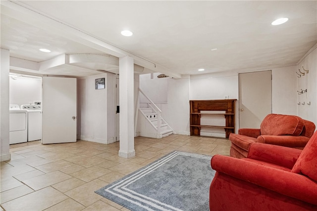 living room with washing machine and clothes dryer and light tile patterned floors