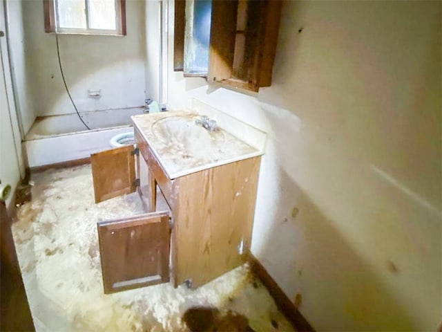 bathroom featuring washtub / shower combination and vanity