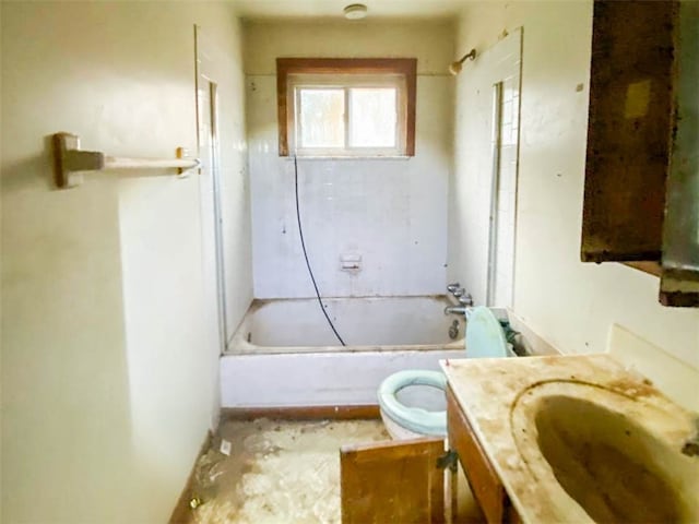 full bathroom featuring tiled shower / bath, vanity, and toilet