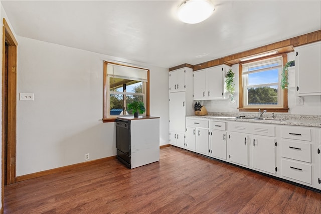 kitchen with sink, white cabinetry, and a healthy amount of sunlight