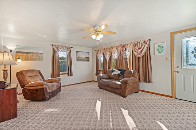 carpeted living room with a healthy amount of sunlight and ceiling fan