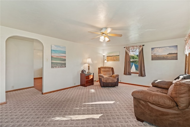 carpeted living room featuring ceiling fan