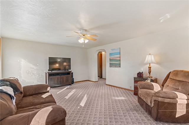 carpeted living room with ceiling fan