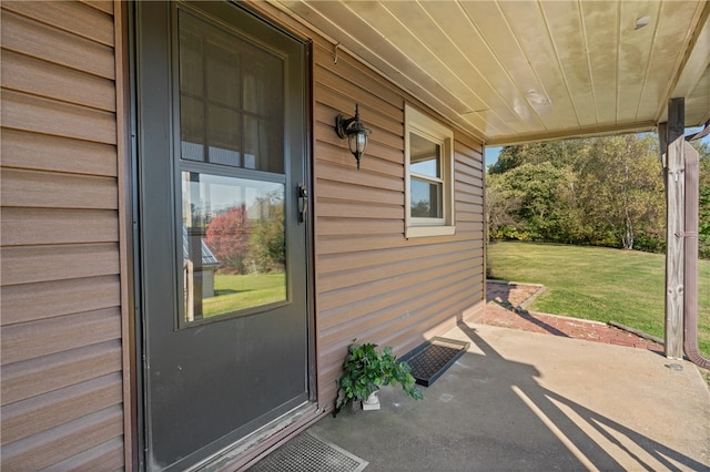 doorway to property featuring a yard