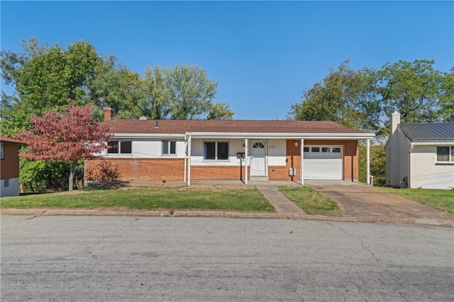 ranch-style house with covered porch, a front yard, and a garage