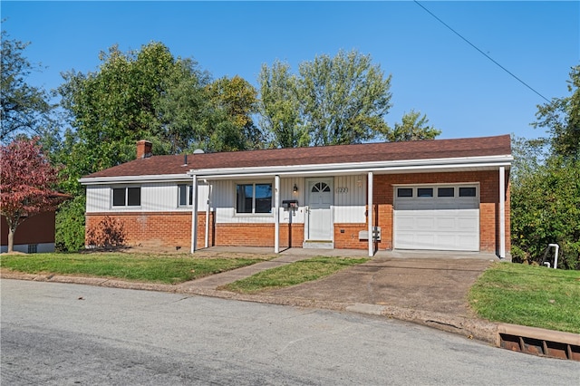 ranch-style home featuring a front yard, a garage, and covered porch