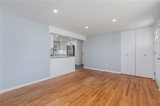 unfurnished living room with light hardwood / wood-style floors