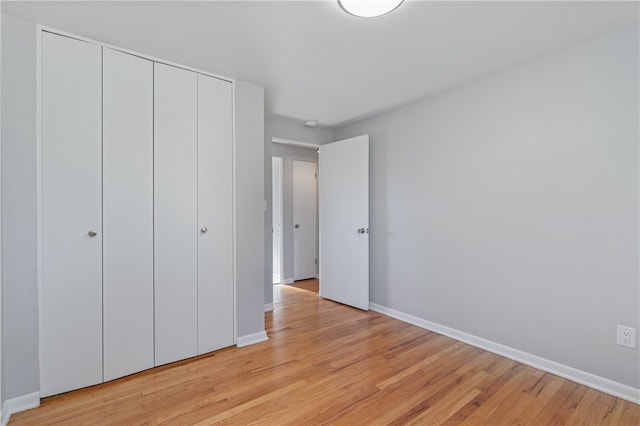 unfurnished bedroom featuring a closet and light hardwood / wood-style floors