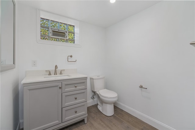 bathroom featuring vanity, hardwood / wood-style floors, and toilet