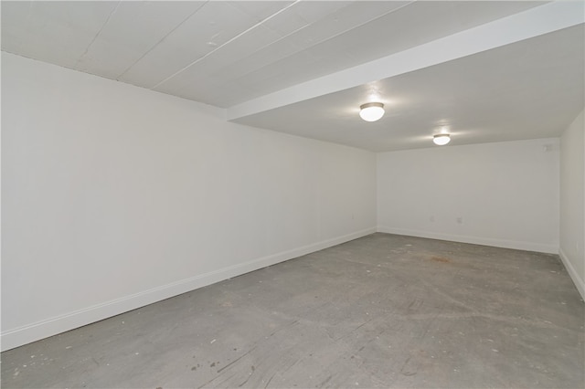 unfurnished room with concrete flooring