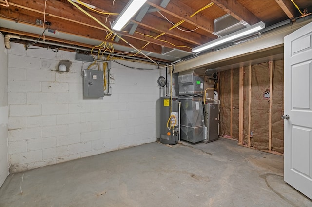 basement featuring gas water heater, heating unit, and electric panel