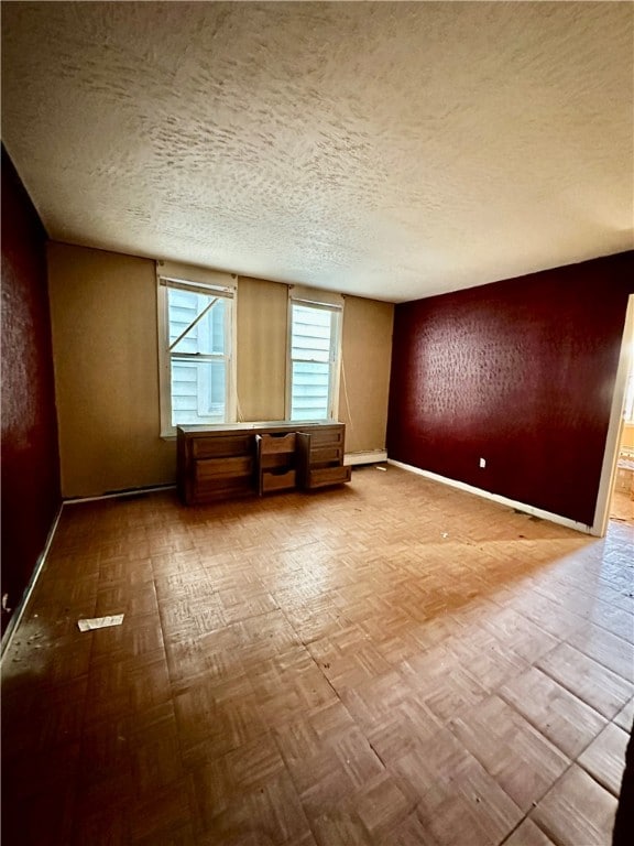 spare room with a textured ceiling