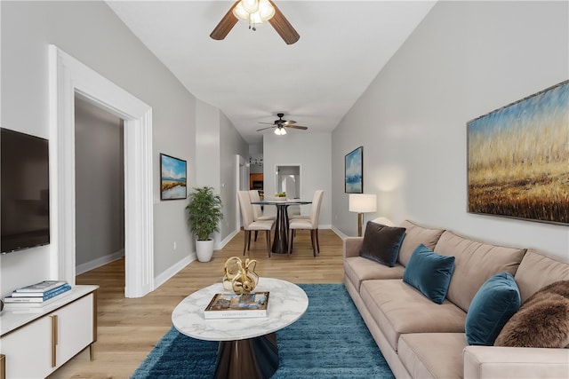 living room featuring ceiling fan and light hardwood / wood-style floors