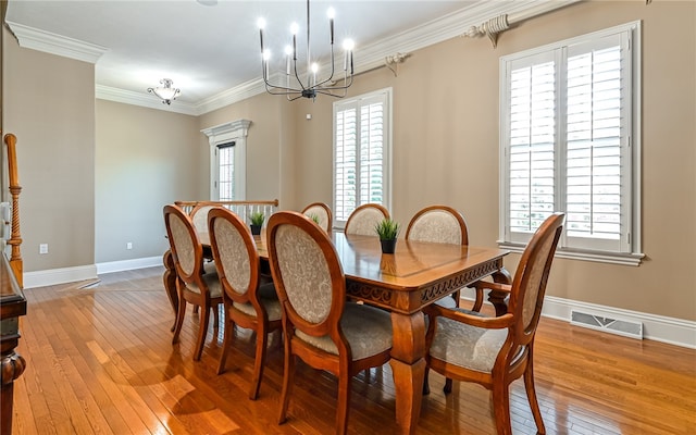 dining area with wood-type flooring, crown molding, and a healthy amount of sunlight