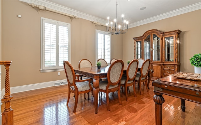 dining room featuring ornamental molding, light wood-type flooring, and a wealth of natural light