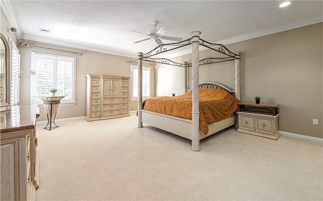 carpeted bedroom featuring ornamental molding and ceiling fan