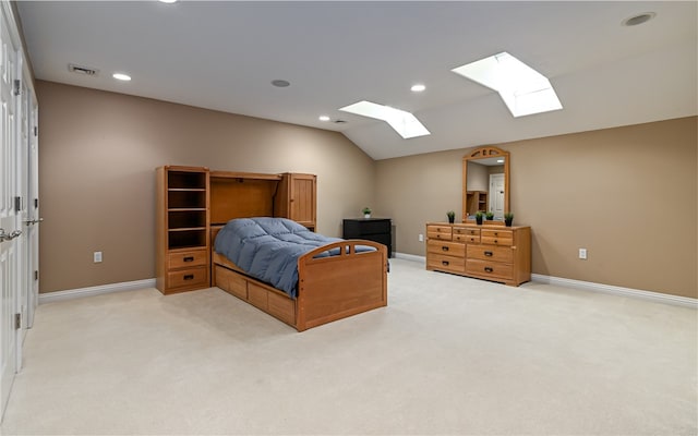 bedroom with light colored carpet and lofted ceiling with skylight