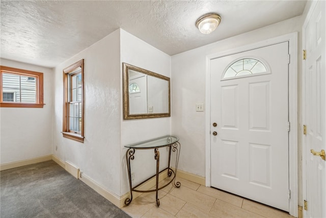 foyer with a textured ceiling