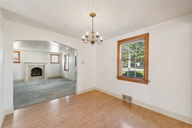 interior space with hardwood / wood-style floors and an inviting chandelier